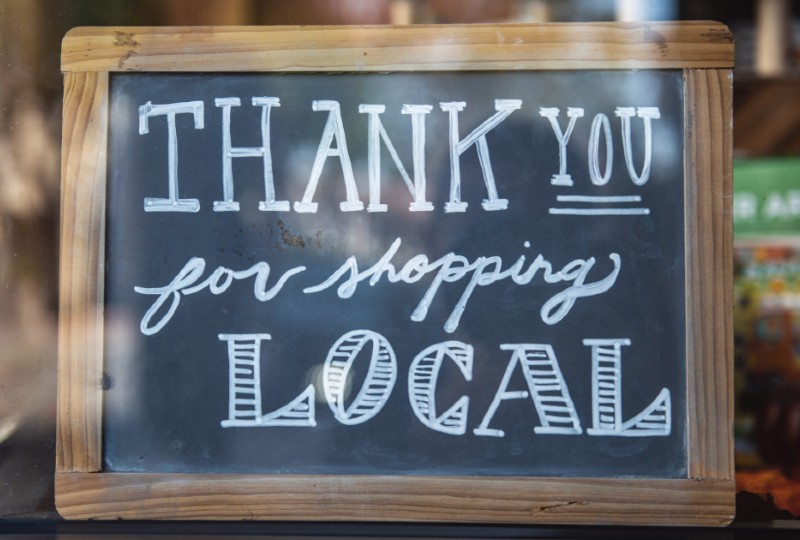 Chalkboard with wooden frame reads "Thank you for shopping local."