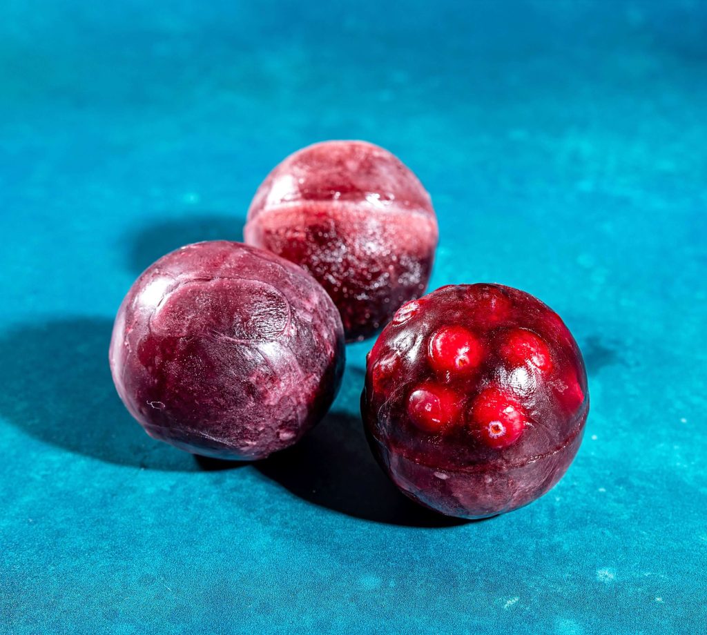 B.C. cherry juice and cranberry ice spheres for festive cocktails. 
