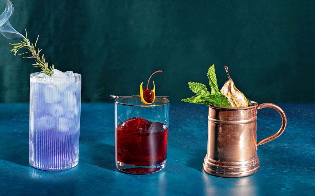 A lineup of three festive cocktails each made with a different spirit distilled in B.C.