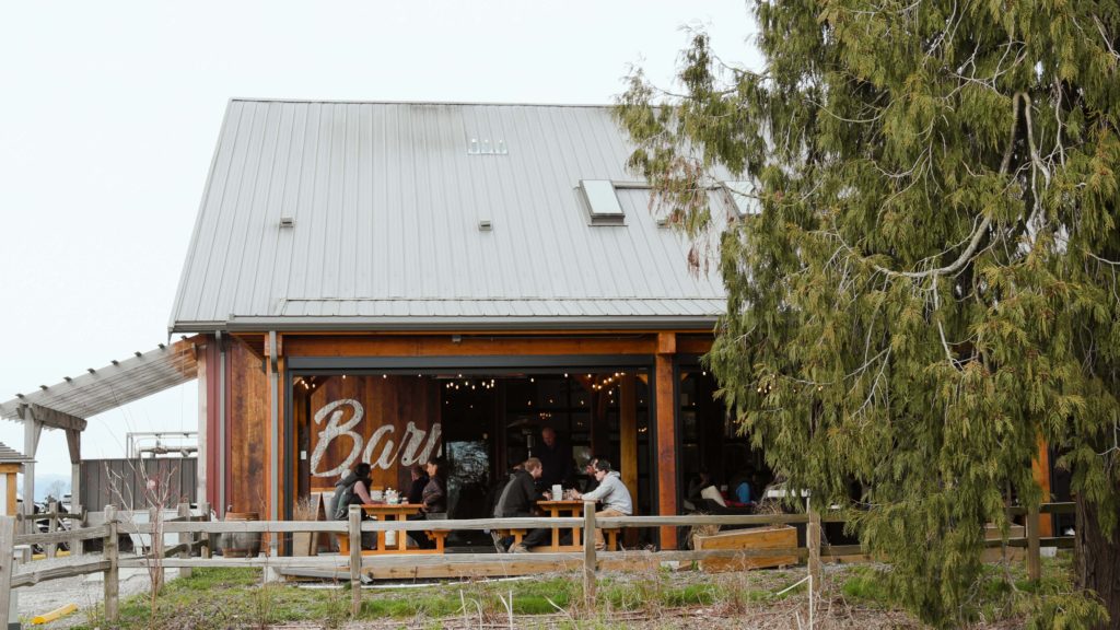 People sit on a patio at a brewery with B.C. beer.